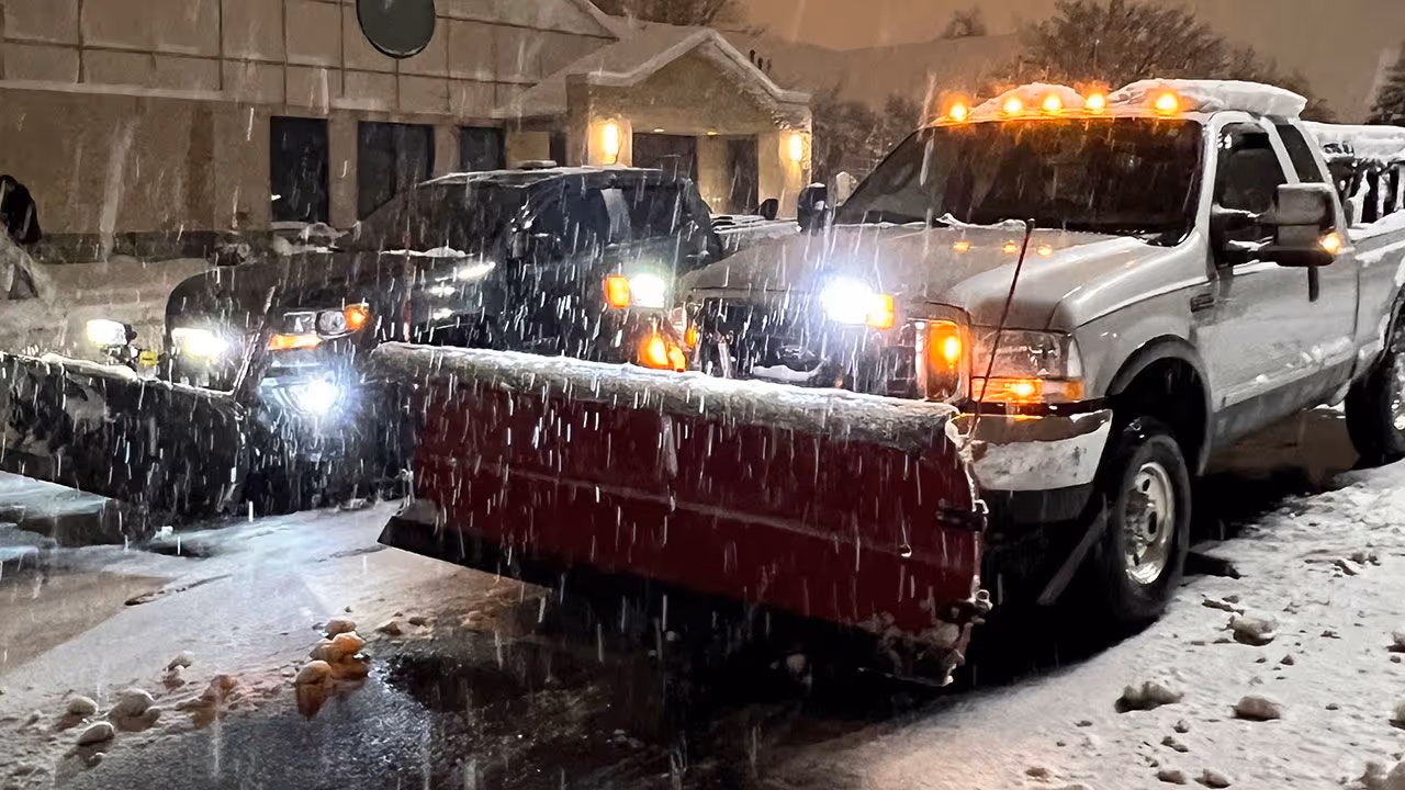commercial snow plowing service clearing parking lot by Jeff's Lawn And Snow in Kenosha and Racine Counties Wisconsin