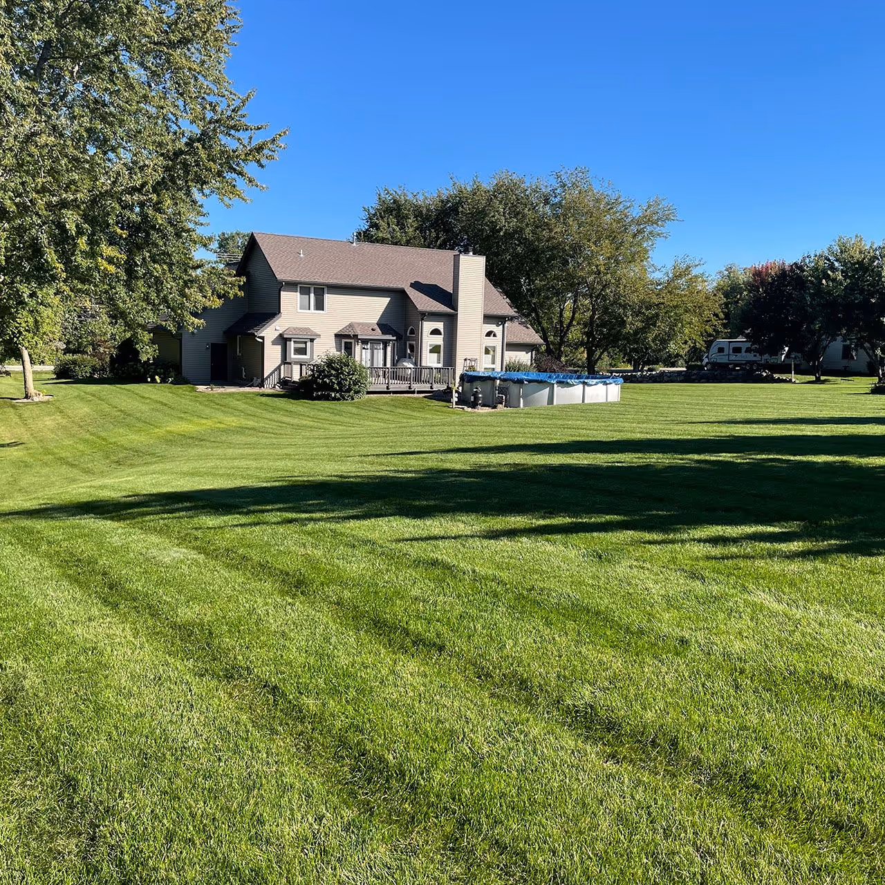 residential lawn care service with freshly mowed striped grass near me