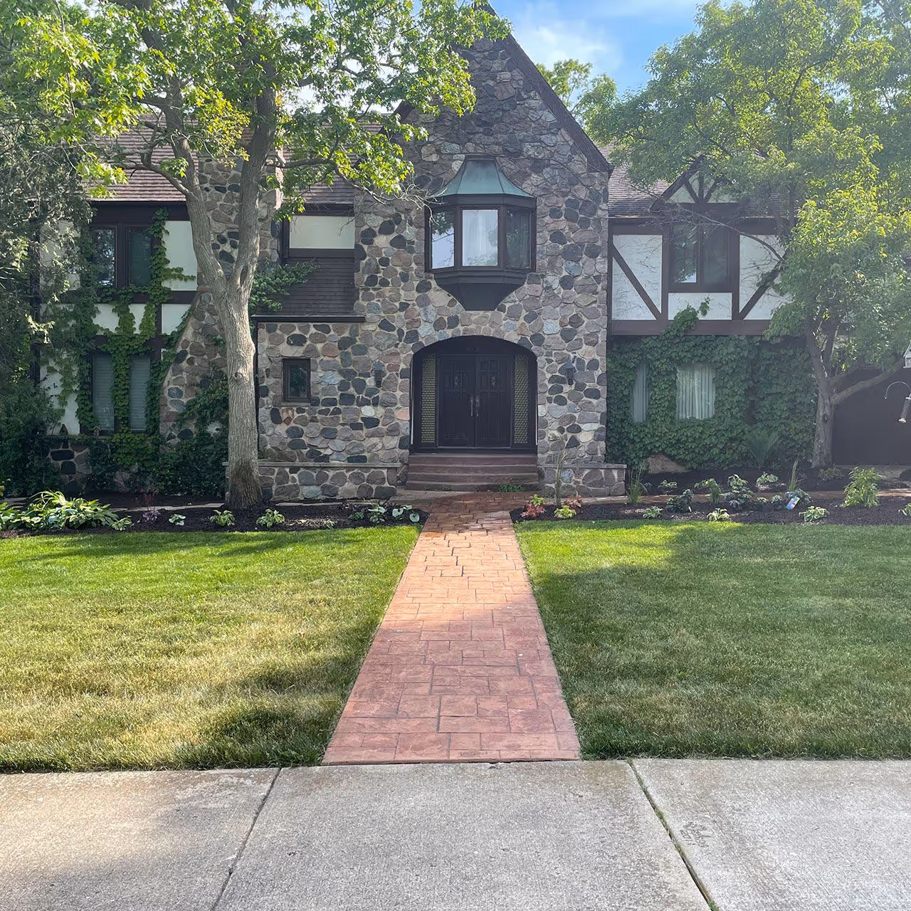 residential lawn care service with freshly mowed striped grass near me