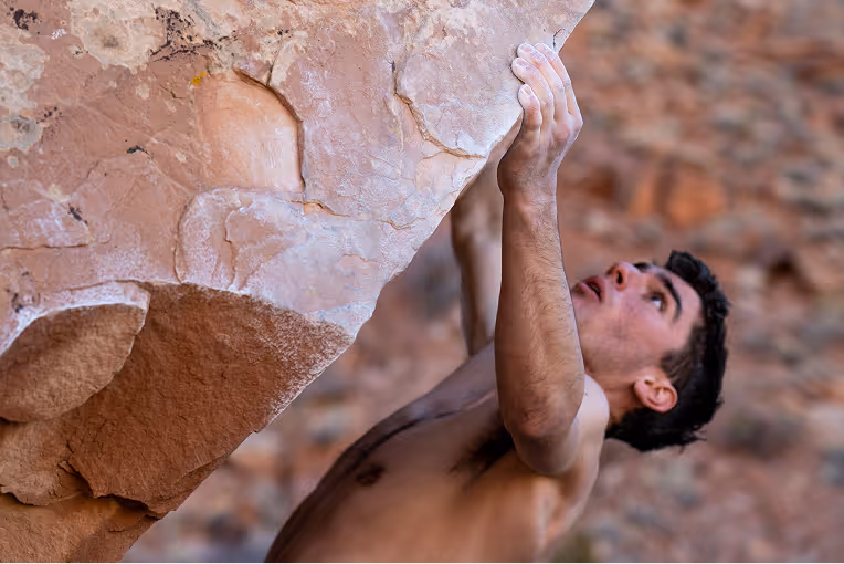 Rock climber bouldering on a steep incline