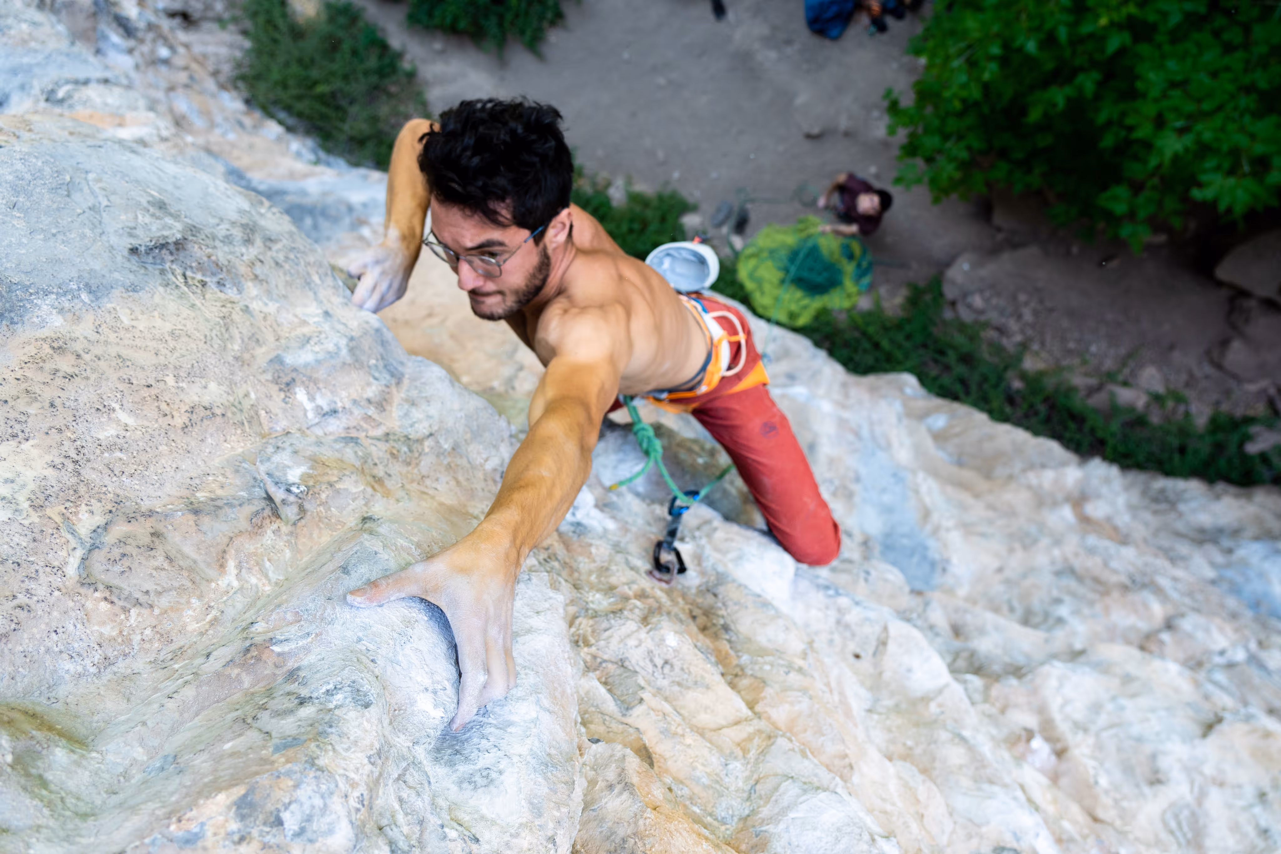 Rock climber climbing on a flat rock face