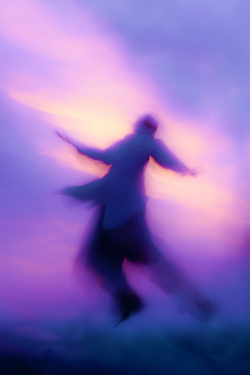 Dreamy abstract image of a figure leaping in soft blue and purple tones.