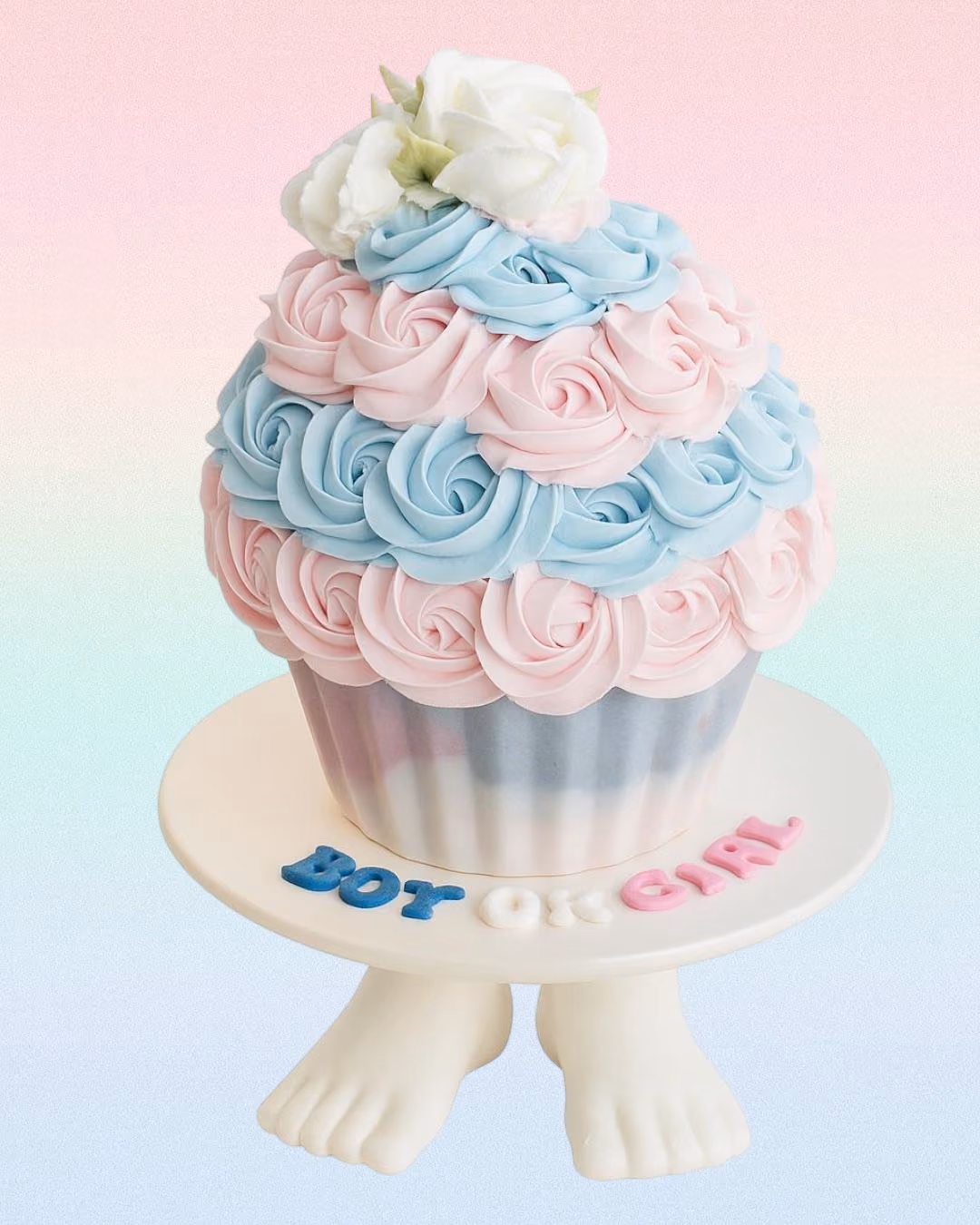 Bouquet of colorful buttercream flowers resembling roses, hydrangeas, and daisies on a wooden surface.