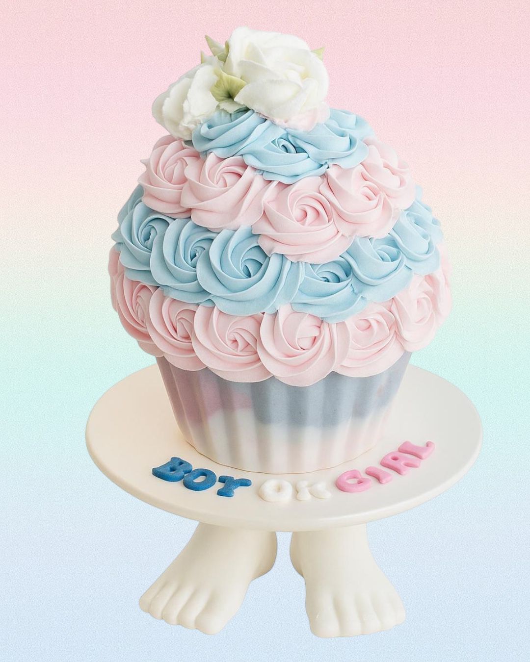 Bouquet of colorful buttercream flowers resembling roses, hydrangeas, and daisies on a wooden surface.