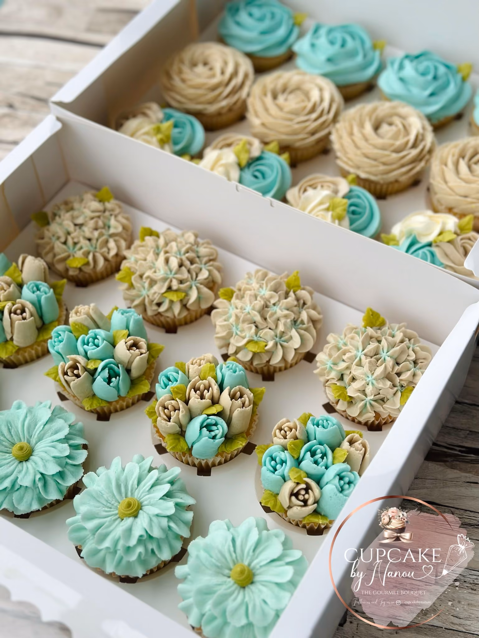 Bouquet of colorful flowers made from frosting on cupcakes, arranged with pink, red, and white floral designs.