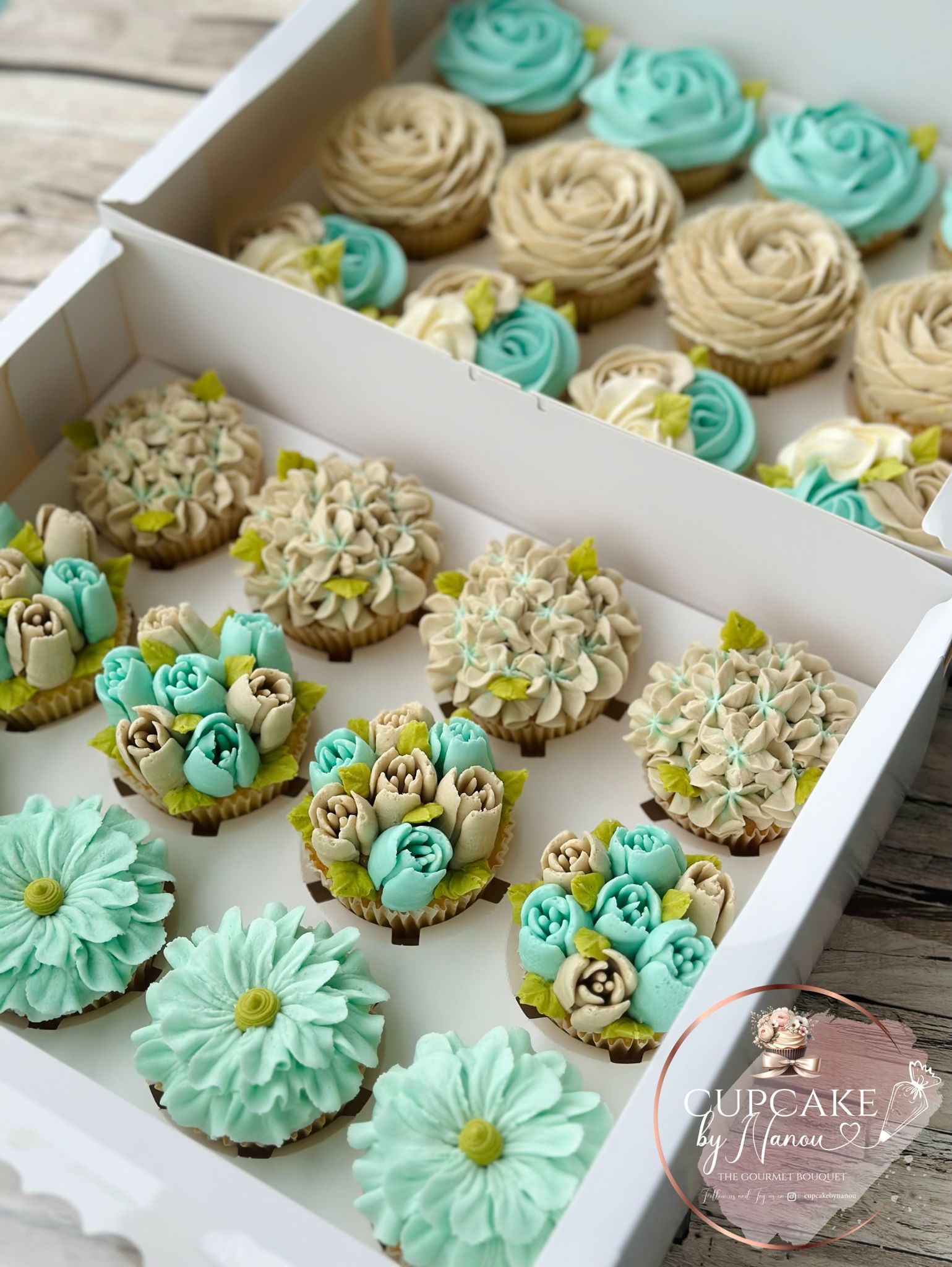 Bouquet of colorful flowers made from frosting on cupcakes, arranged with pink, red, and white floral designs.