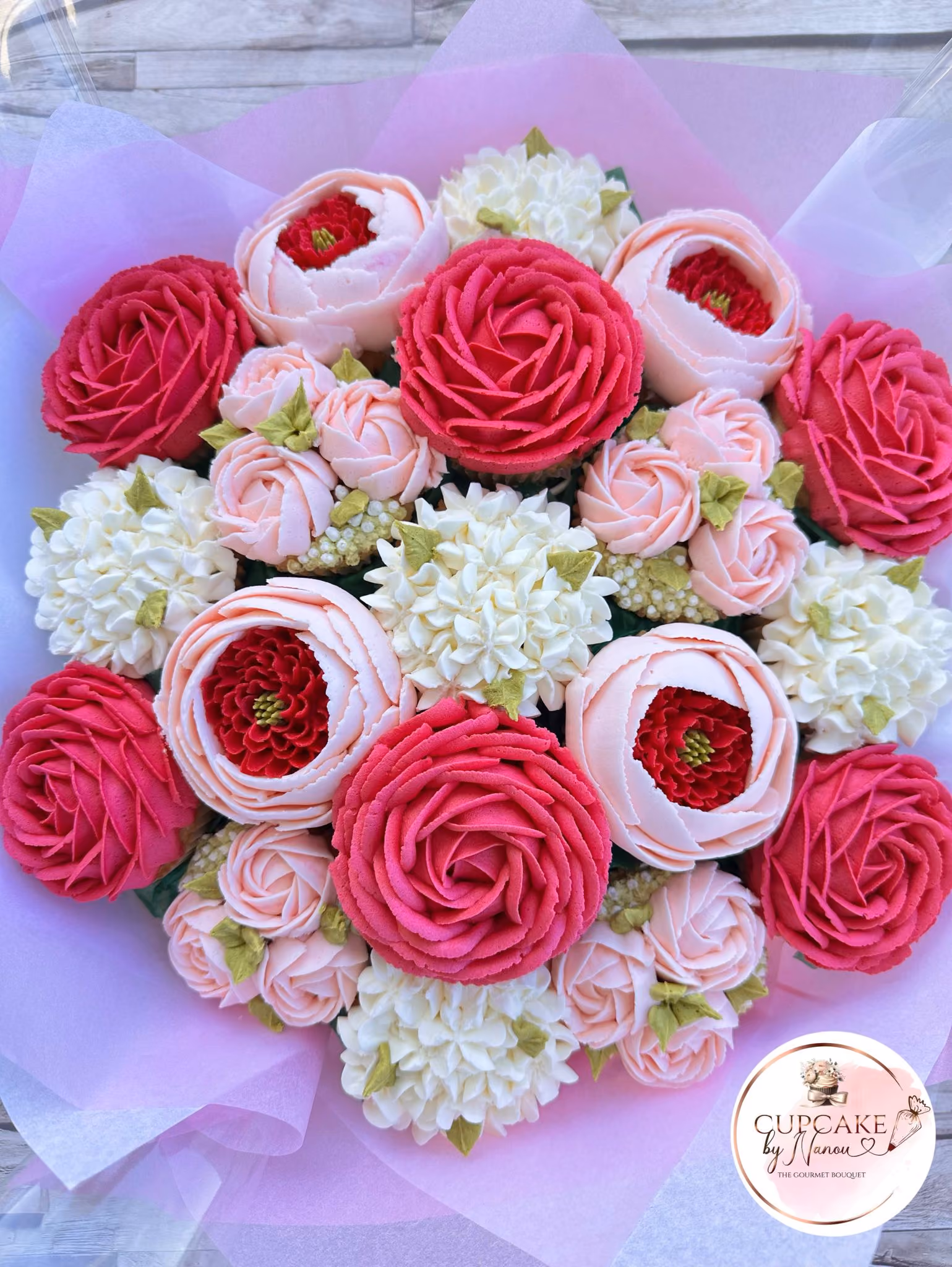 Bouquet of red rose-shaped cupcakes with pink tissue and a heart tag saying Happy Valentine’s Day.