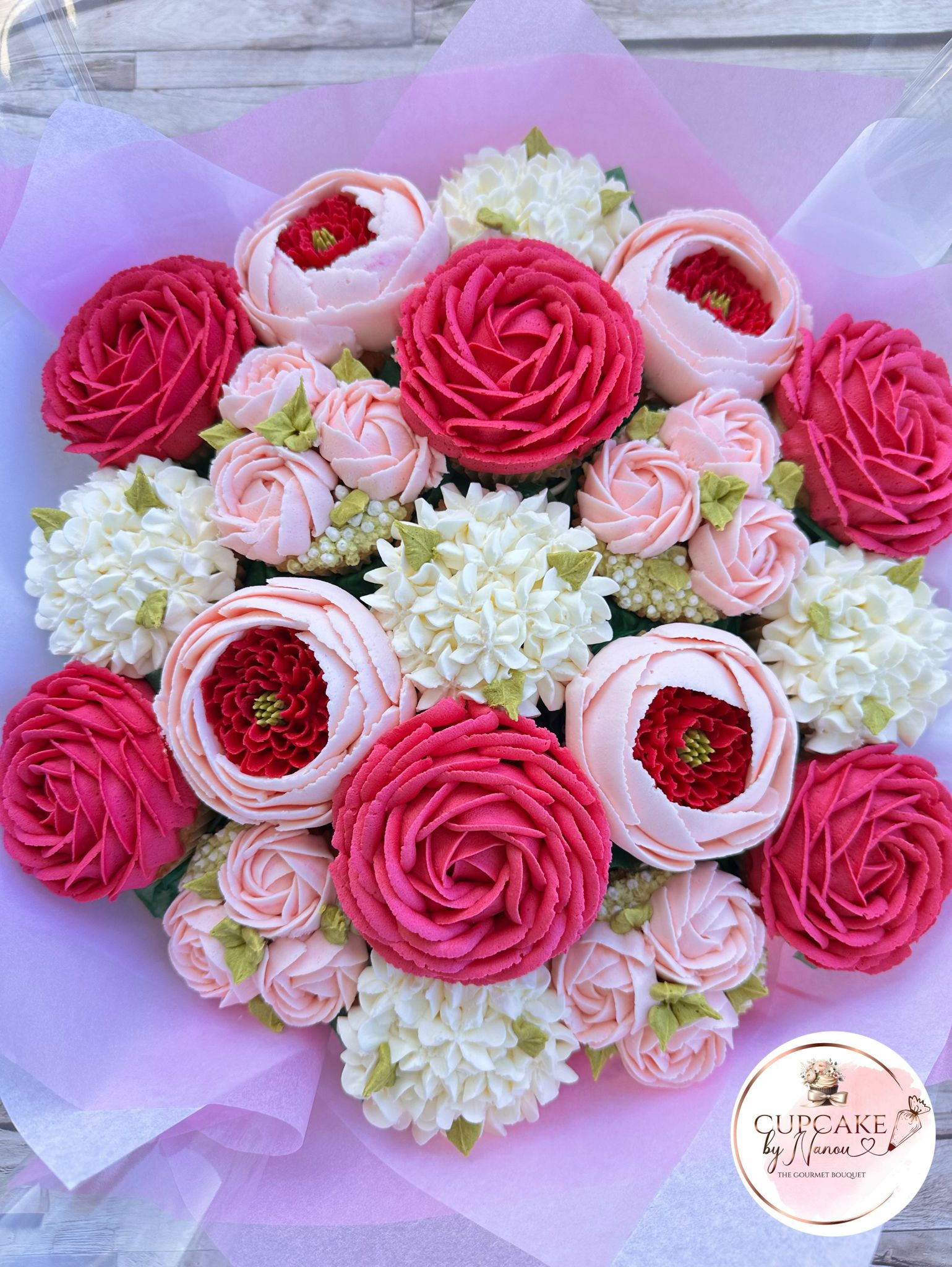 Bouquet of red rose-shaped cupcakes with pink tissue and a heart tag saying Happy Valentine’s Day.