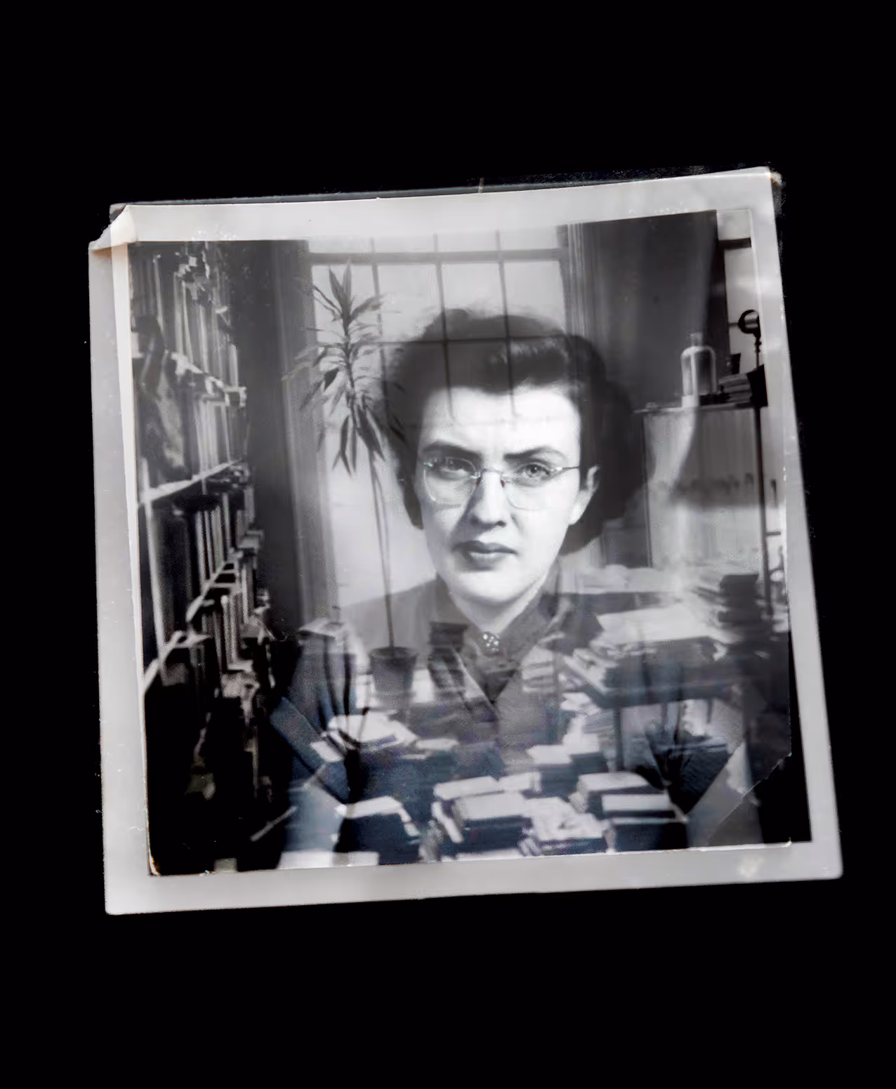A woman from the '70s overlayed a library/studio, black and white photography