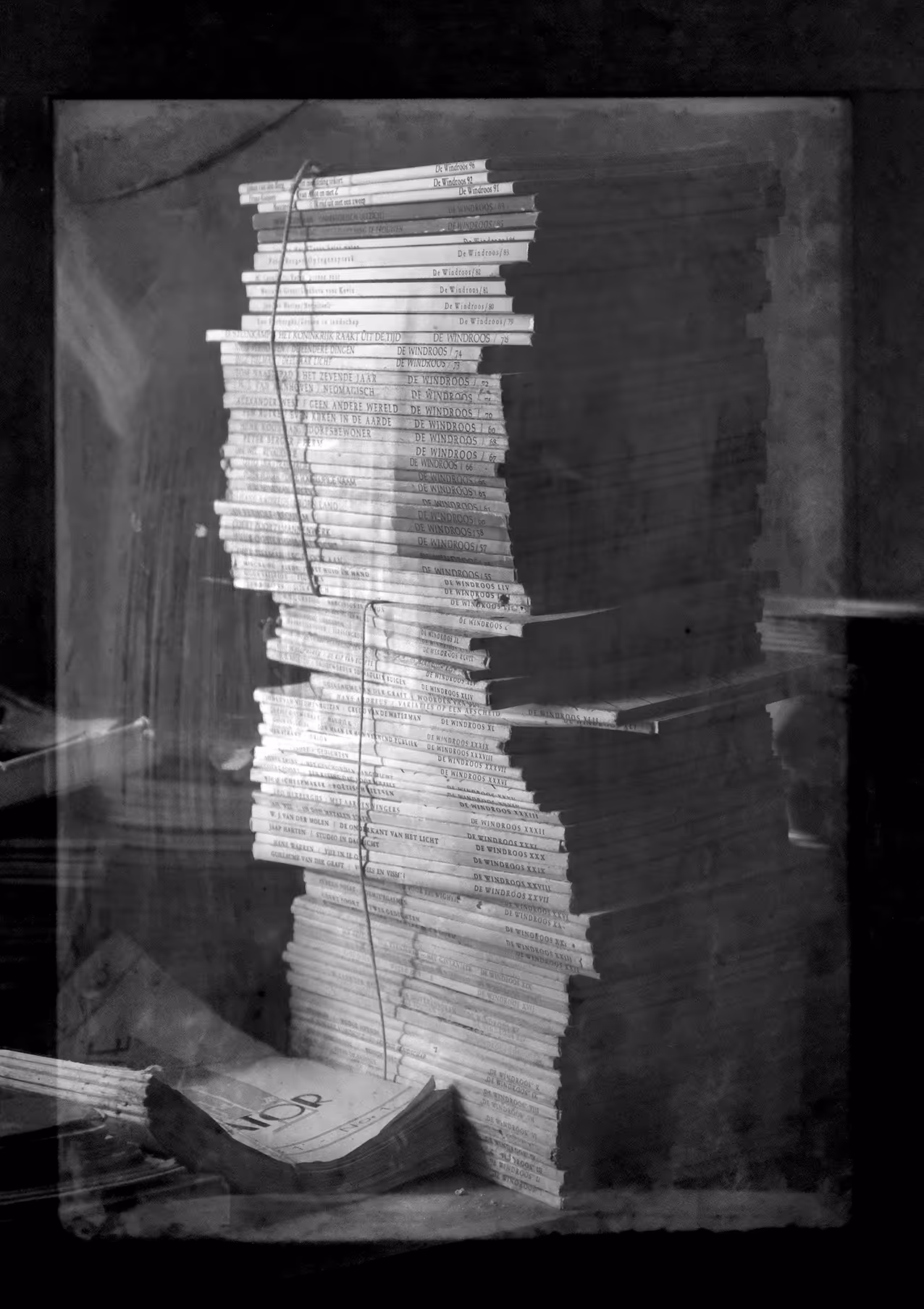 A stack of magazines, black and white picture
