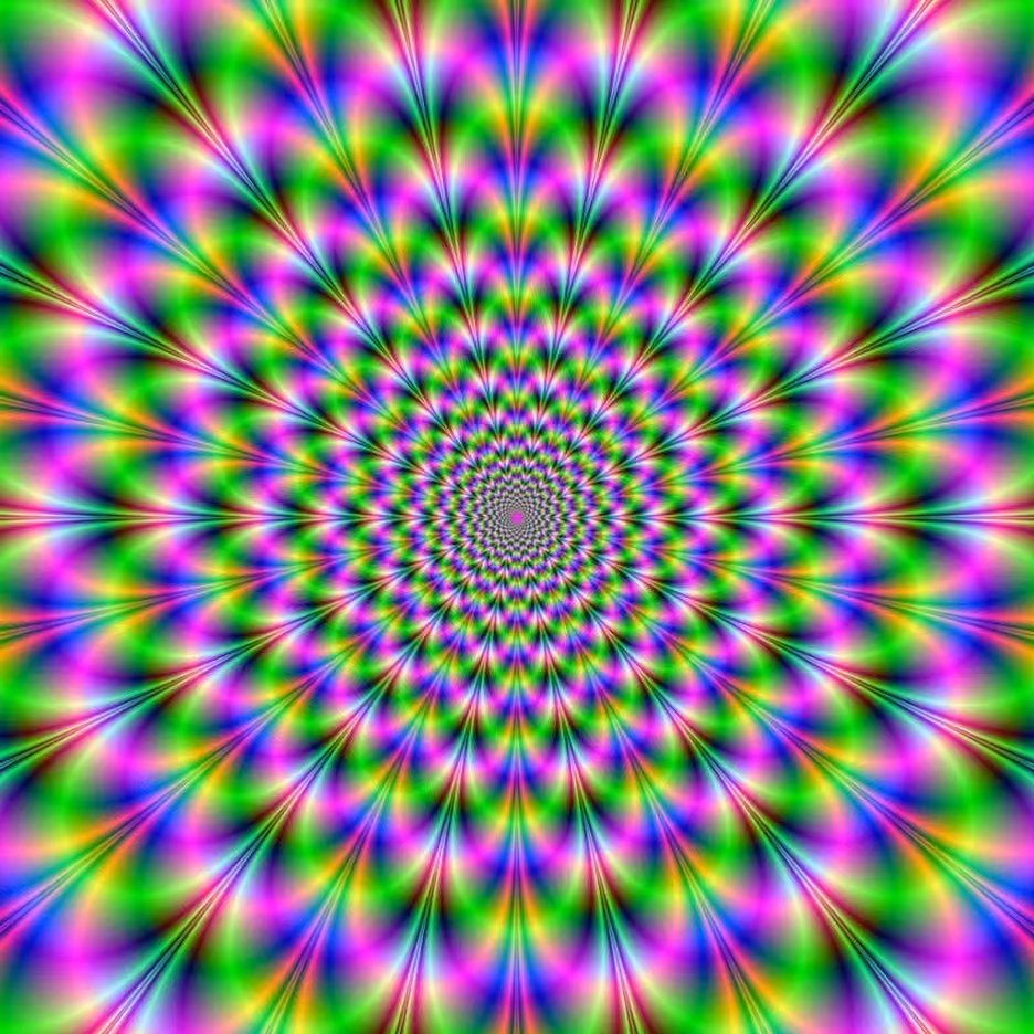 A vibrant, neon psychedelic pattern radiating outwards in concentric circles of bright green, pink, purple, and blue hues.