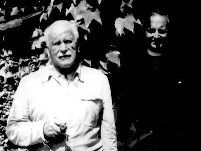 High-contrast black and white photograph of Carl Jung and Victor White standing outside together against ivy-covered leaves.