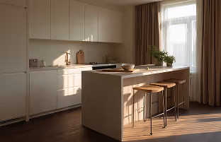 A modern kitchen designed in beige and cream tones with abundant natural light, emphasizing a warm, sophisticated atmosphere and high-quality architectural finishes.