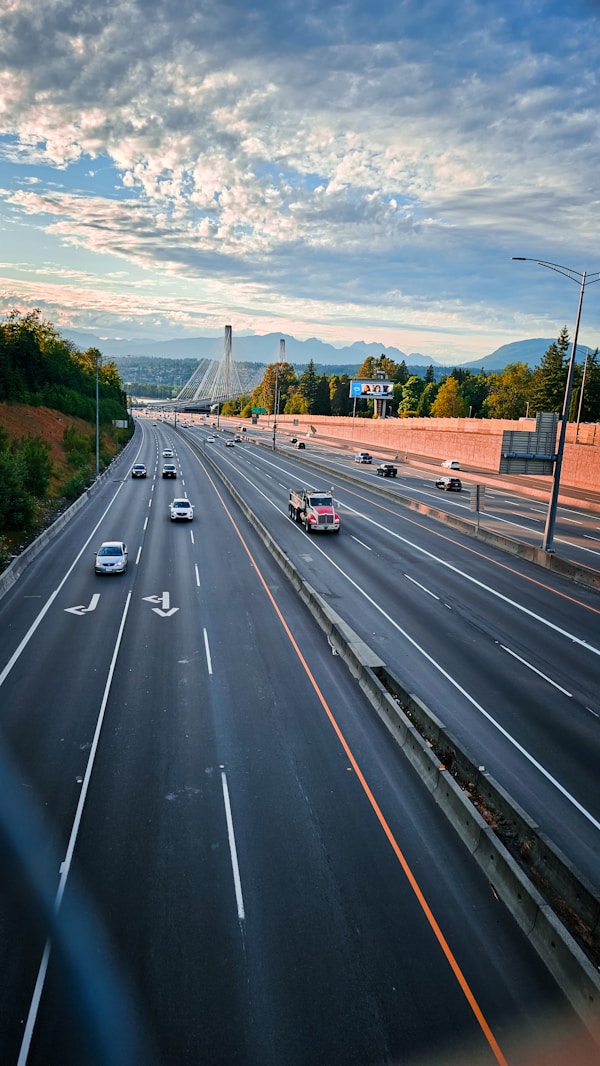 a highway with a bunch of cars driving down it