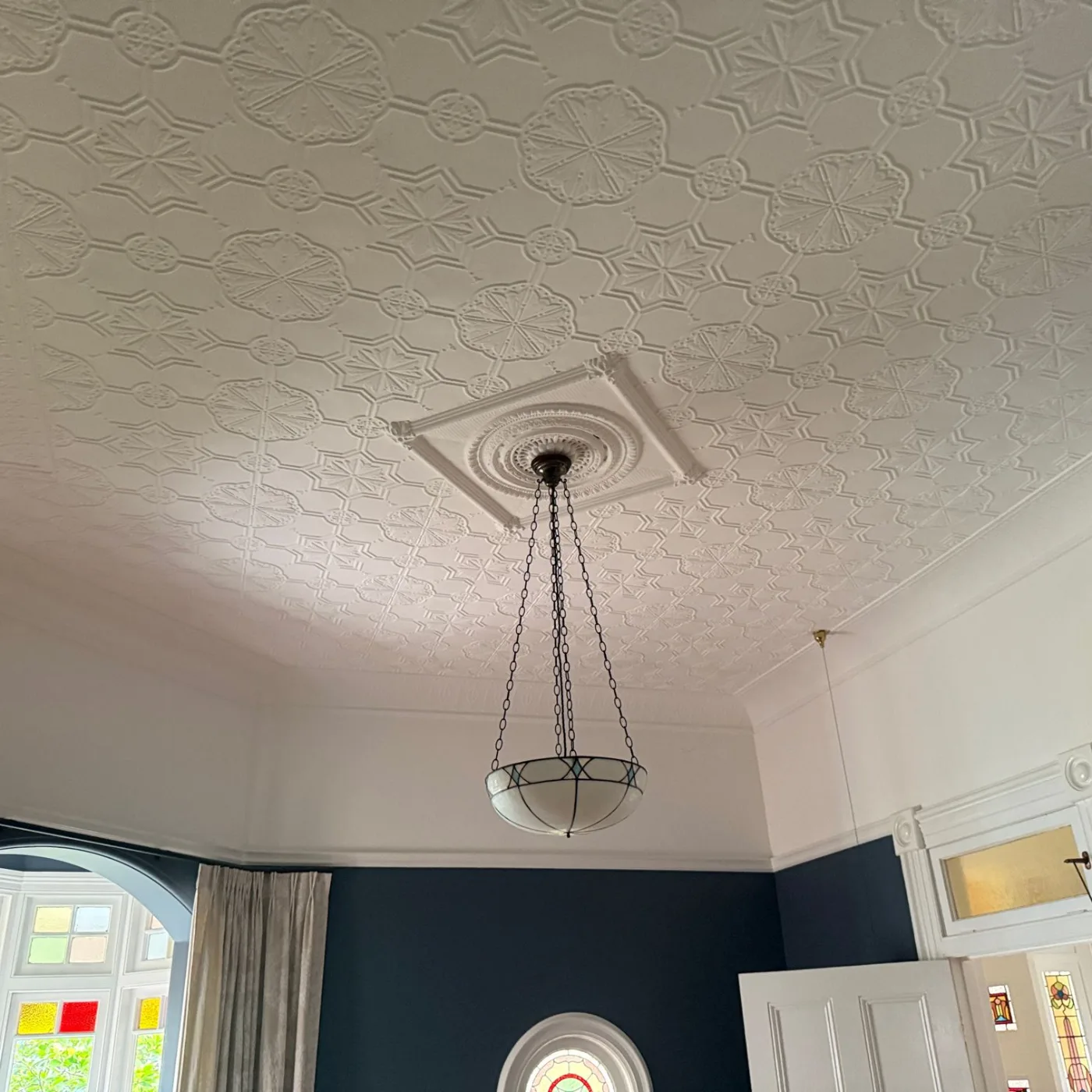 Original pendant light under the ornate plaster ceiling before the new pendant was installed