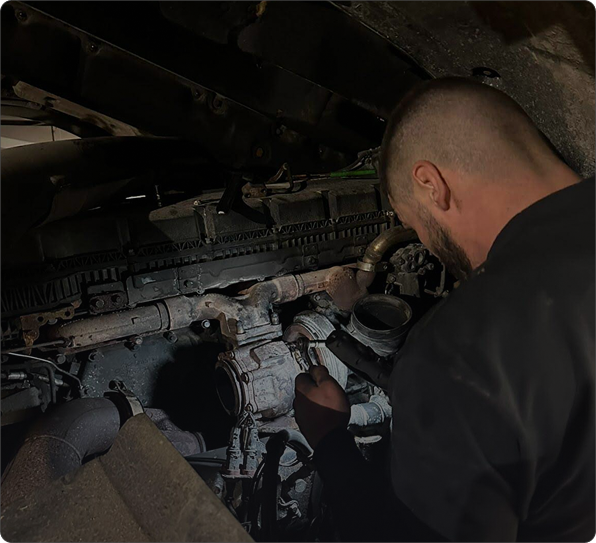 truck mechanic repairing truck on european highway