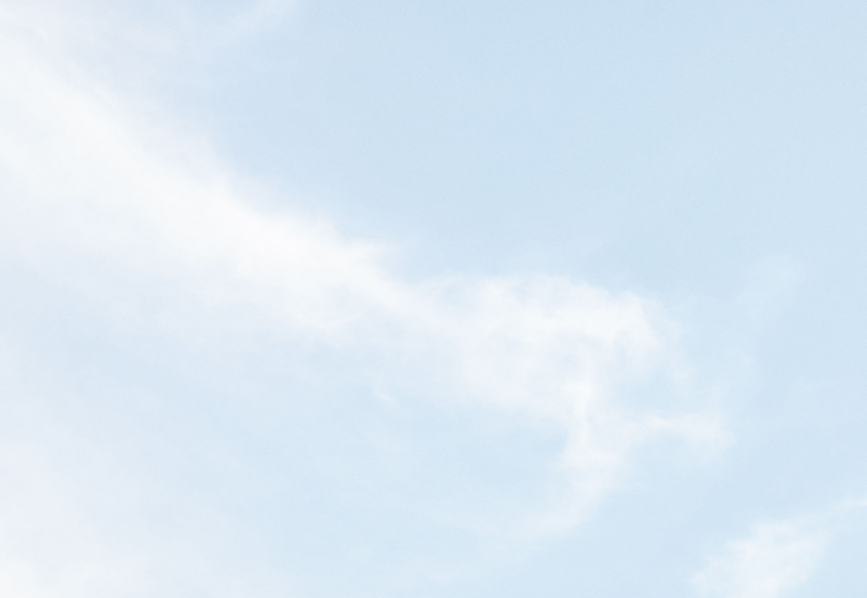 Light blue sky with wispy white clouds.