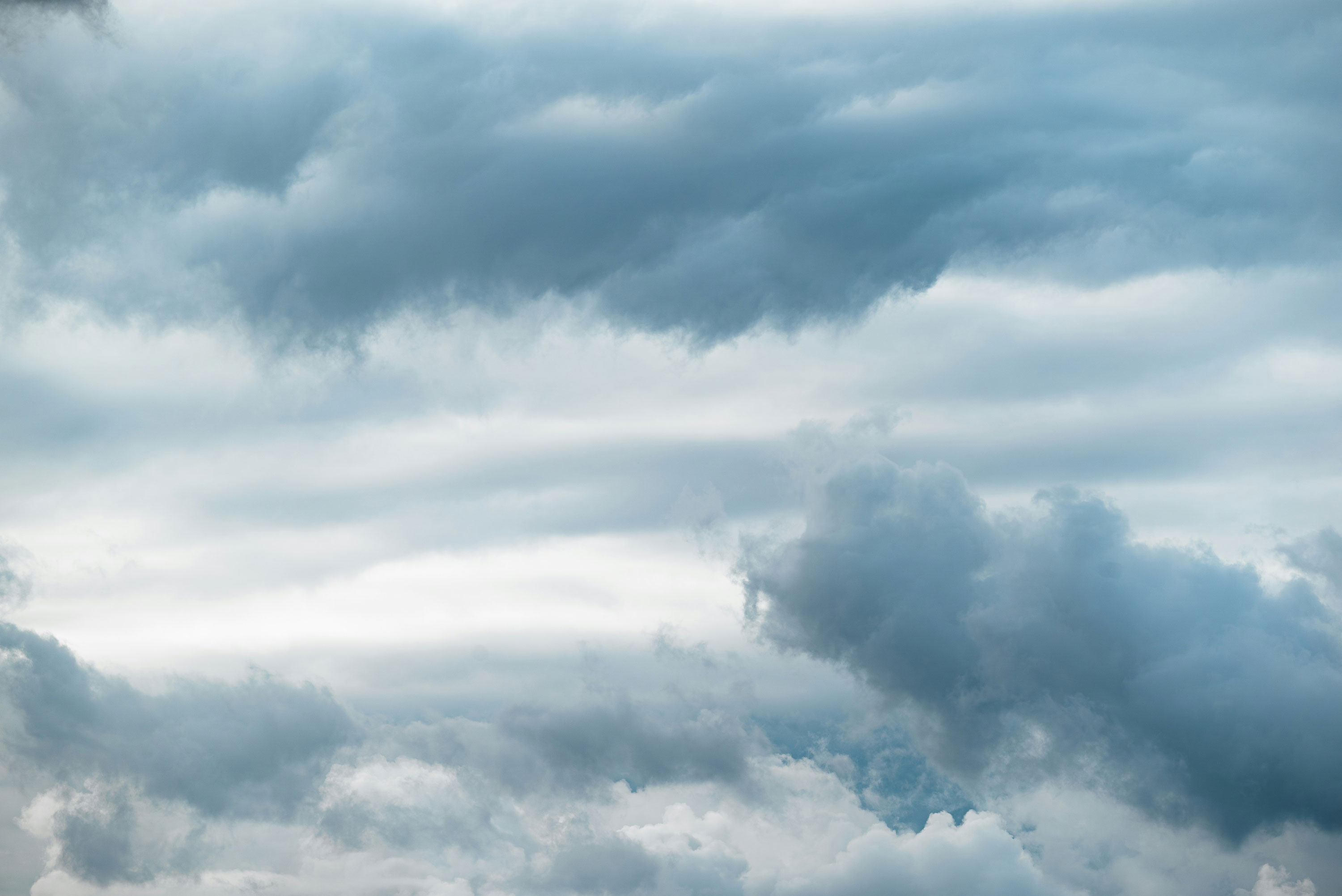 Overcast sky with layers of thick gray and white clouds.