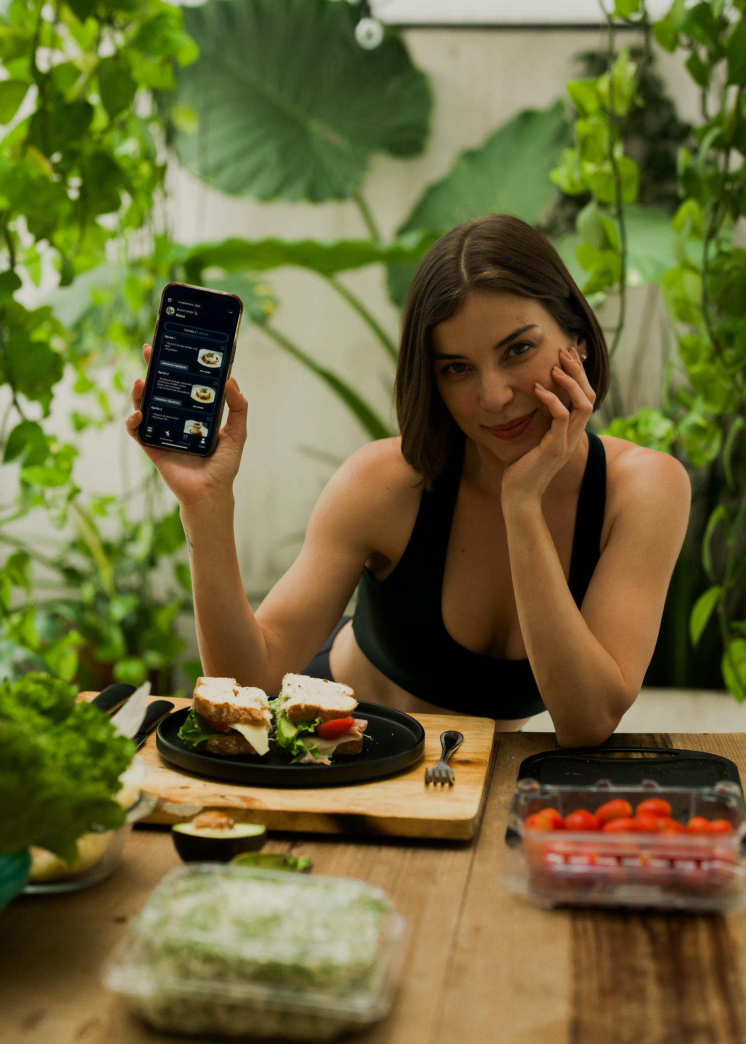 Two people sitting at a wooden table smiling and eating healthy meals with bread and lemon water, with text overlay 'Built around you. Nutrition Plans.'