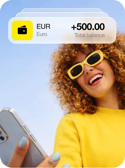 Smiling woman wearing yellow sunglasses and shirt holding a smartphone with a digital card showing 500 euros total balance.