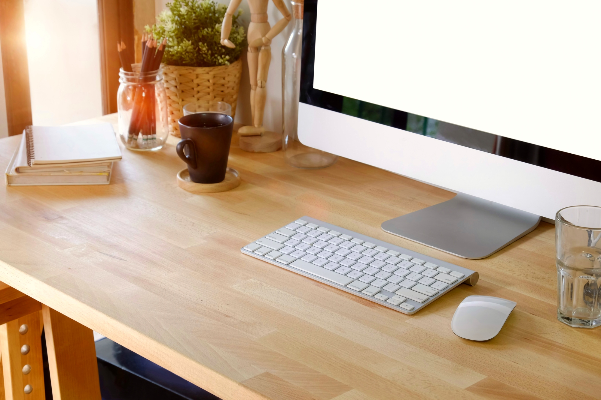 Wood desk and keyboard with a cup of coffee.