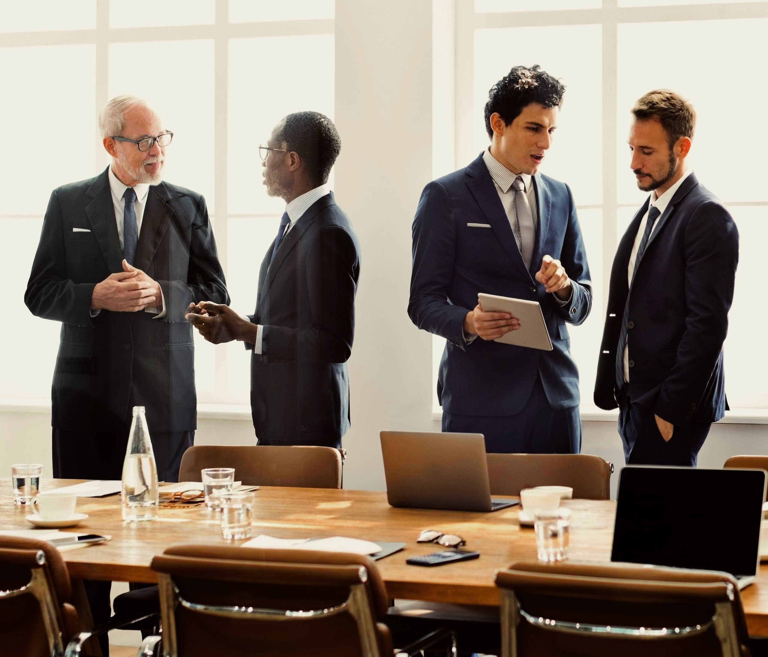 Medium sized group of people dressed professionally in a meeting.
