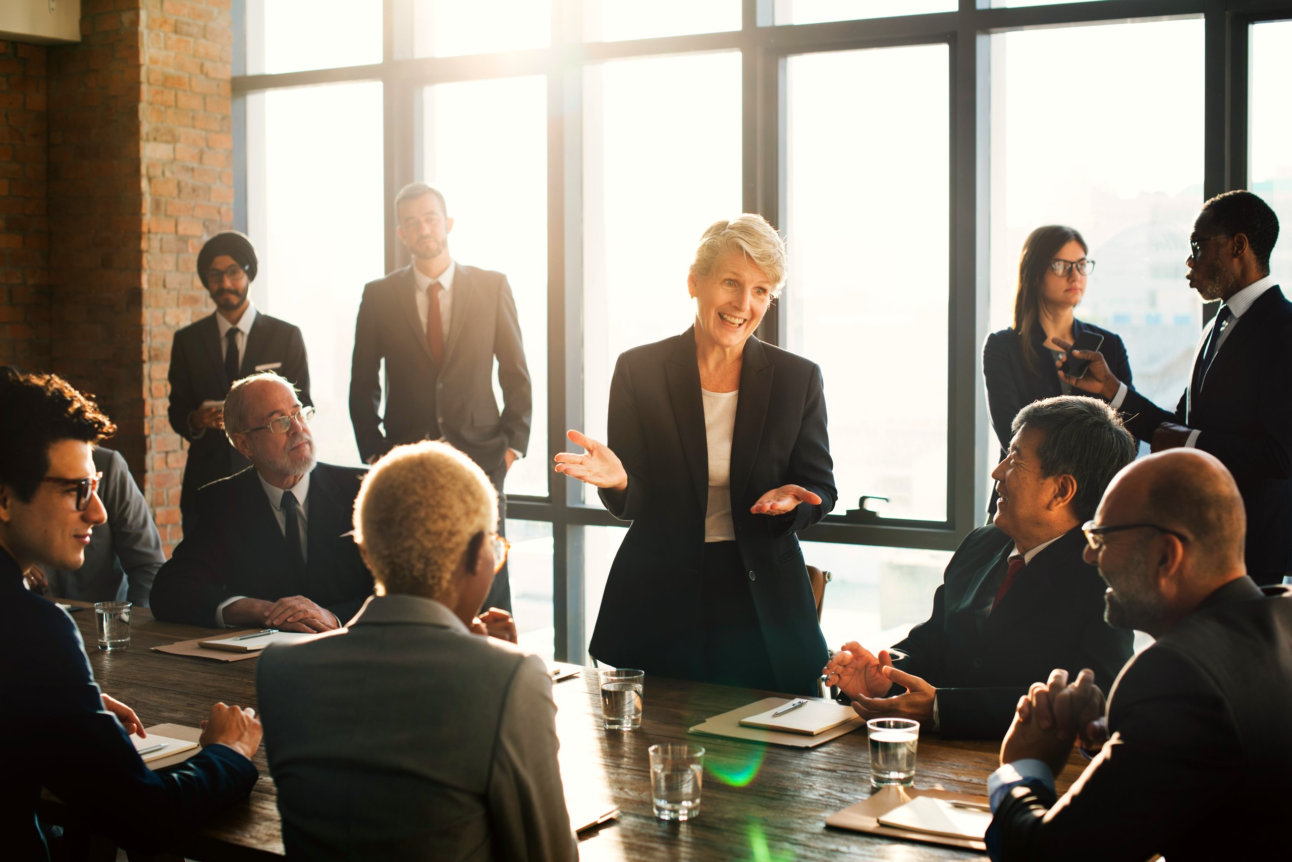 Large group of people dressed professionally in a meeting.