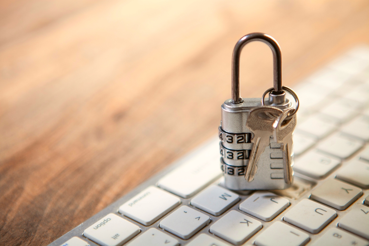 A padlock sitting on a computer keyboard.