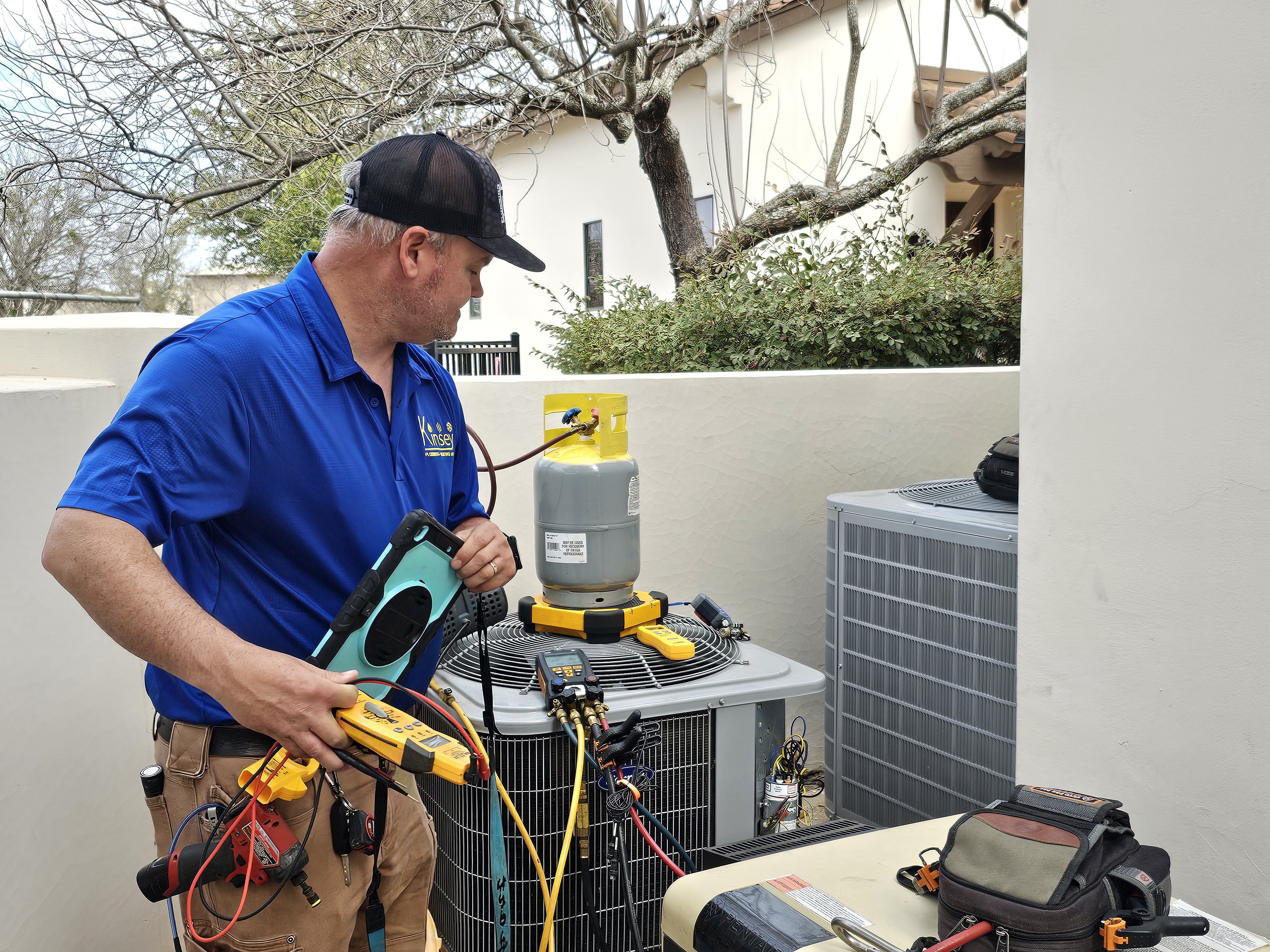 Kinsey heating technician installing heat pump in Cedar Park TX