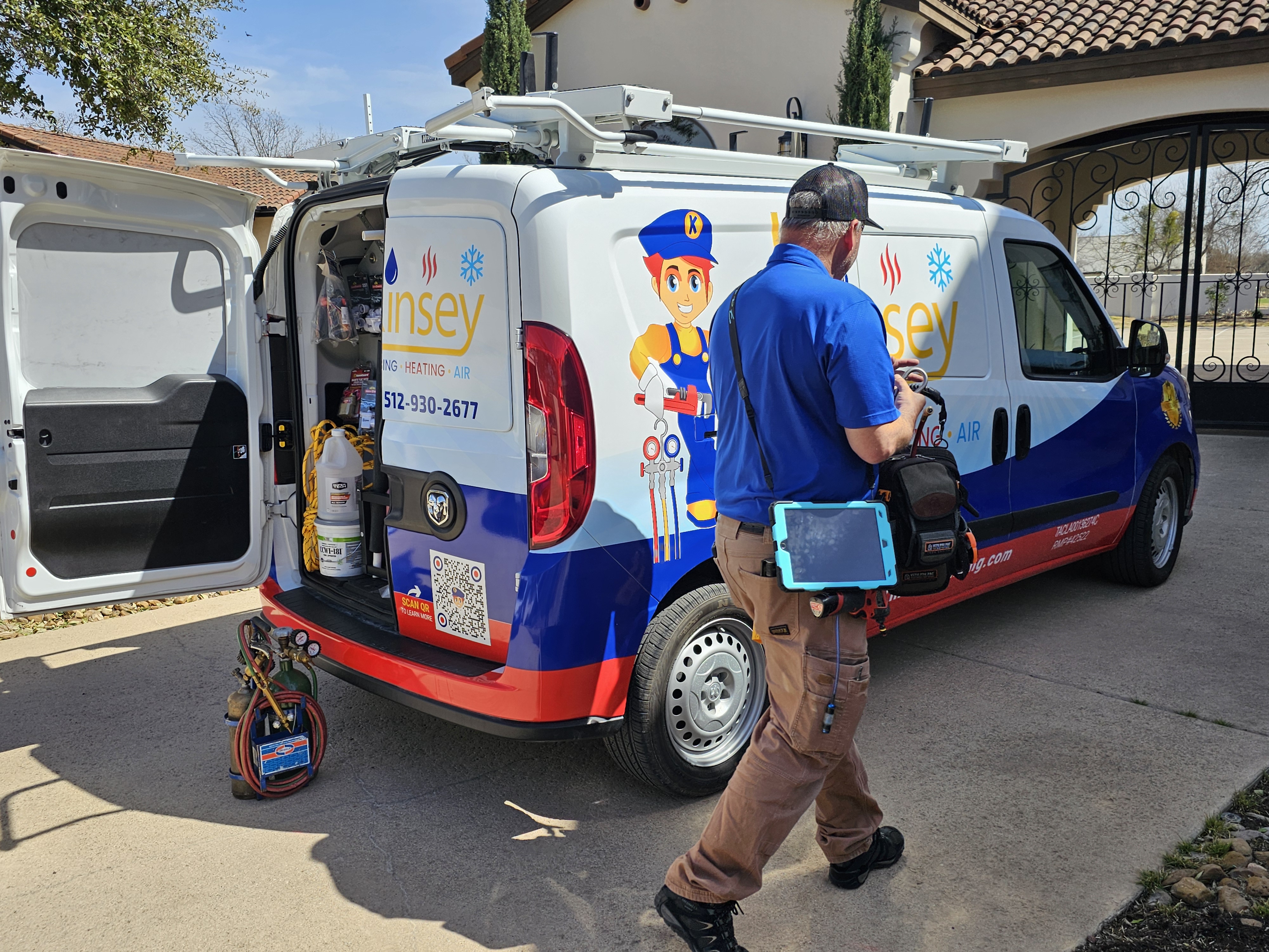 Kinsey HVAC technician checking AC system in Round Rock TX