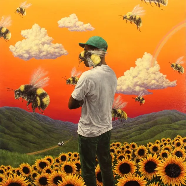 Person in green cap and white shirt standing in a sunflower field with giant bees flying around against an orange sunset sky with clouds.