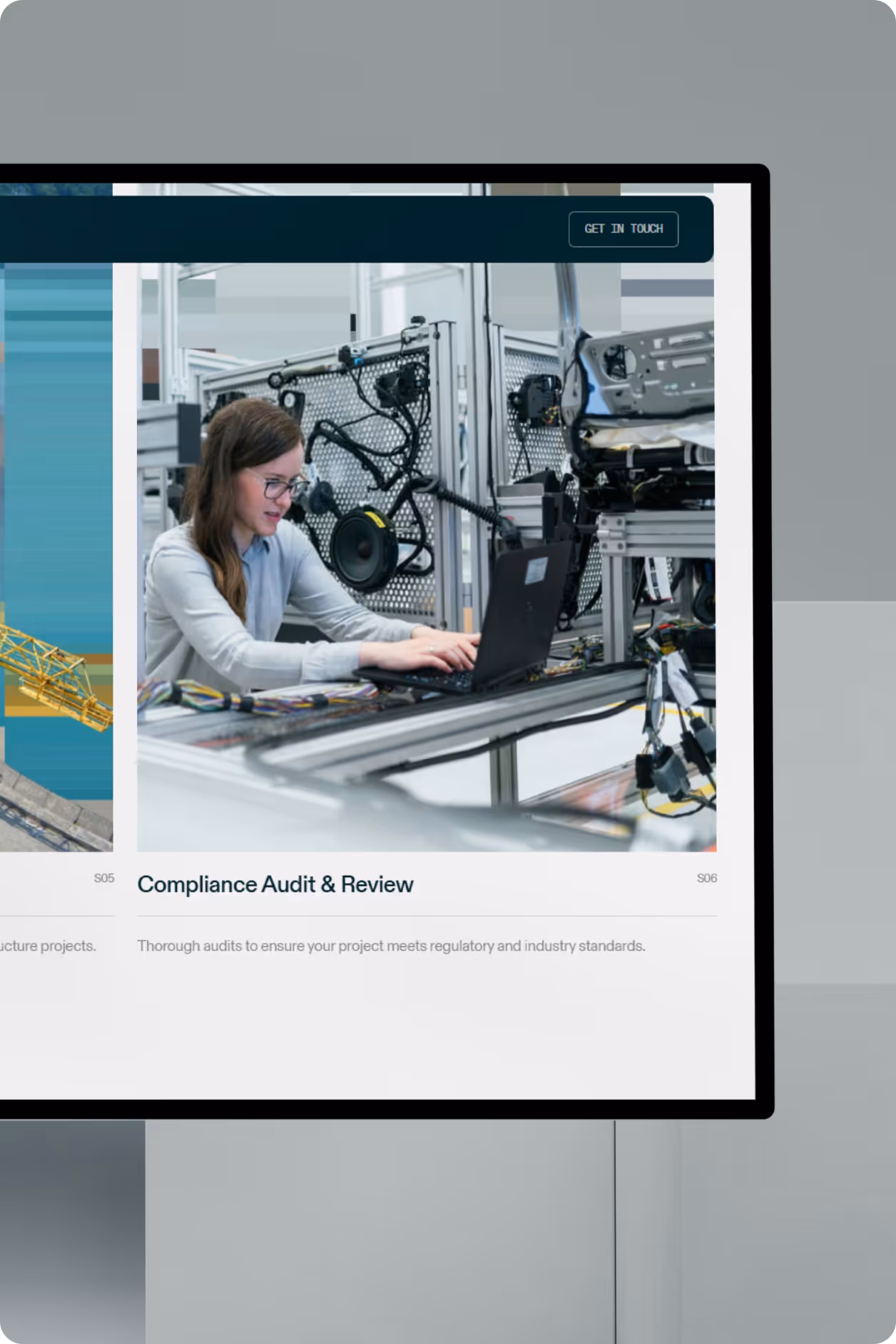 A computer screen showing "The Be Company" website with a "Compliance Audit & Review" section and an engineer working. 