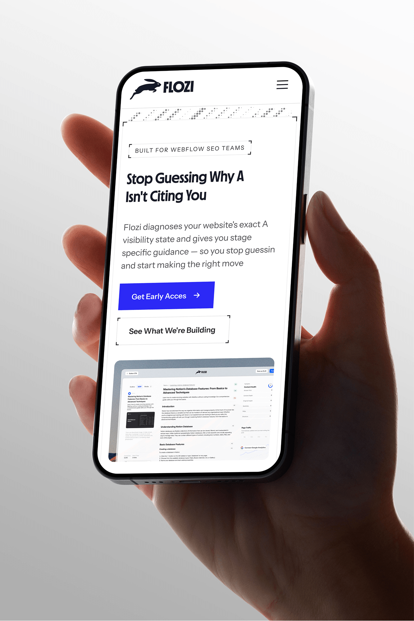 A hand holding a smartphone displaying the Flozi mobile website with the headline "Stop Guessing Why AI Isn't Citing You." 