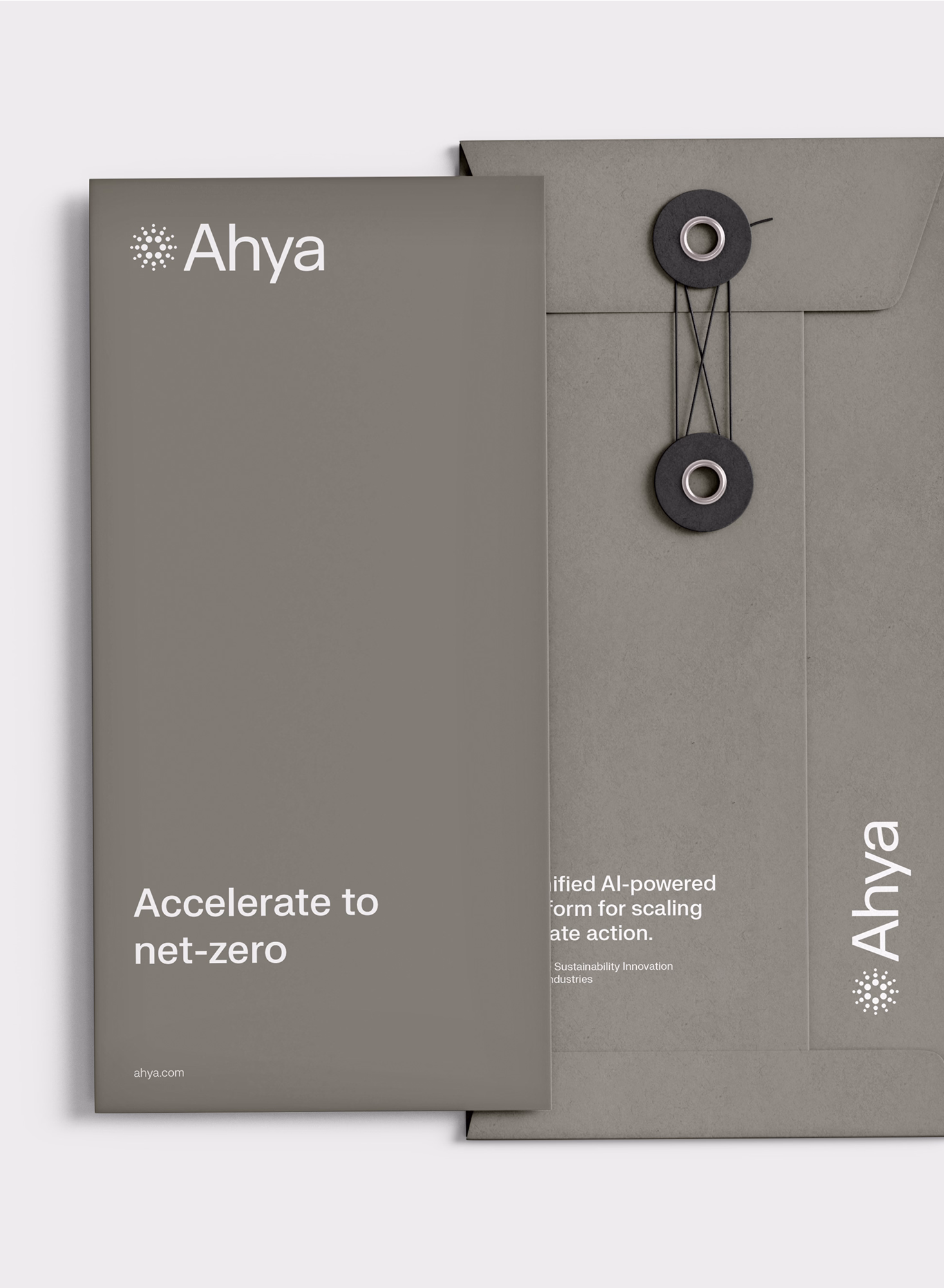 A close-up of a gray vertical string-tie envelope and a matching brochure featuring the slogan "Accelerate to net-zero" and the Ahya logo.  
