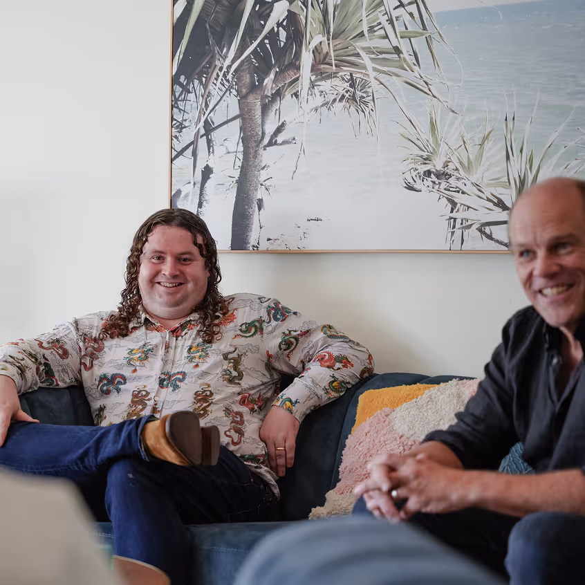 a group of men sitting on a couch