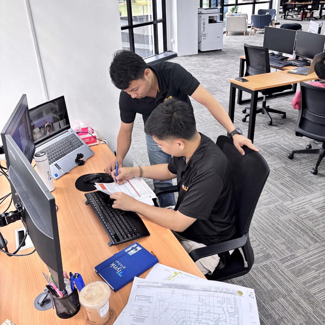 Dedicated offshore construction support staff working at office computers