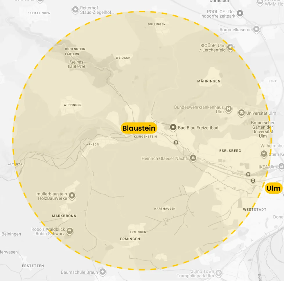 Map showing a highlighted circular area covering Blaustein and Ulm with nearby landmarks and towns.