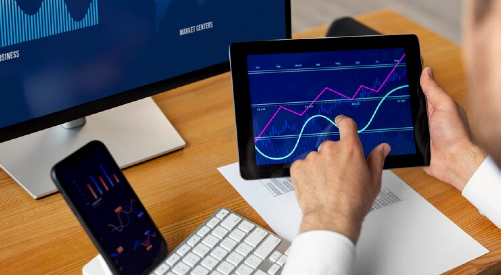 man trading on a tablet - Automated Day Trading