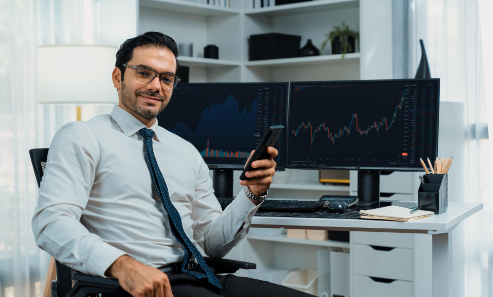 a trader holding a phone - How to Make Money Online Trading