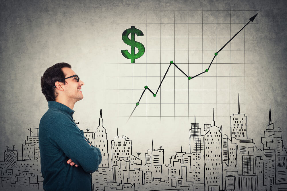 man looking at a trading chart - Day Trading Goals