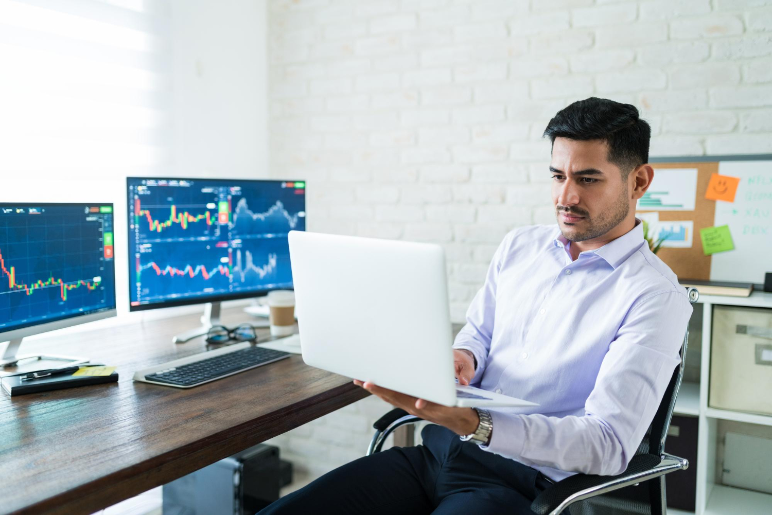 man using a laptop - NFP Trading