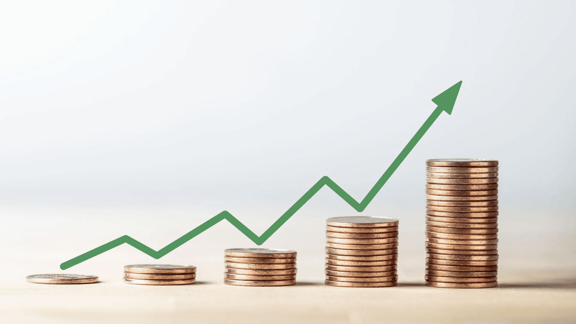 Rising coin stacks with upward arrow - What are REIT Dividends