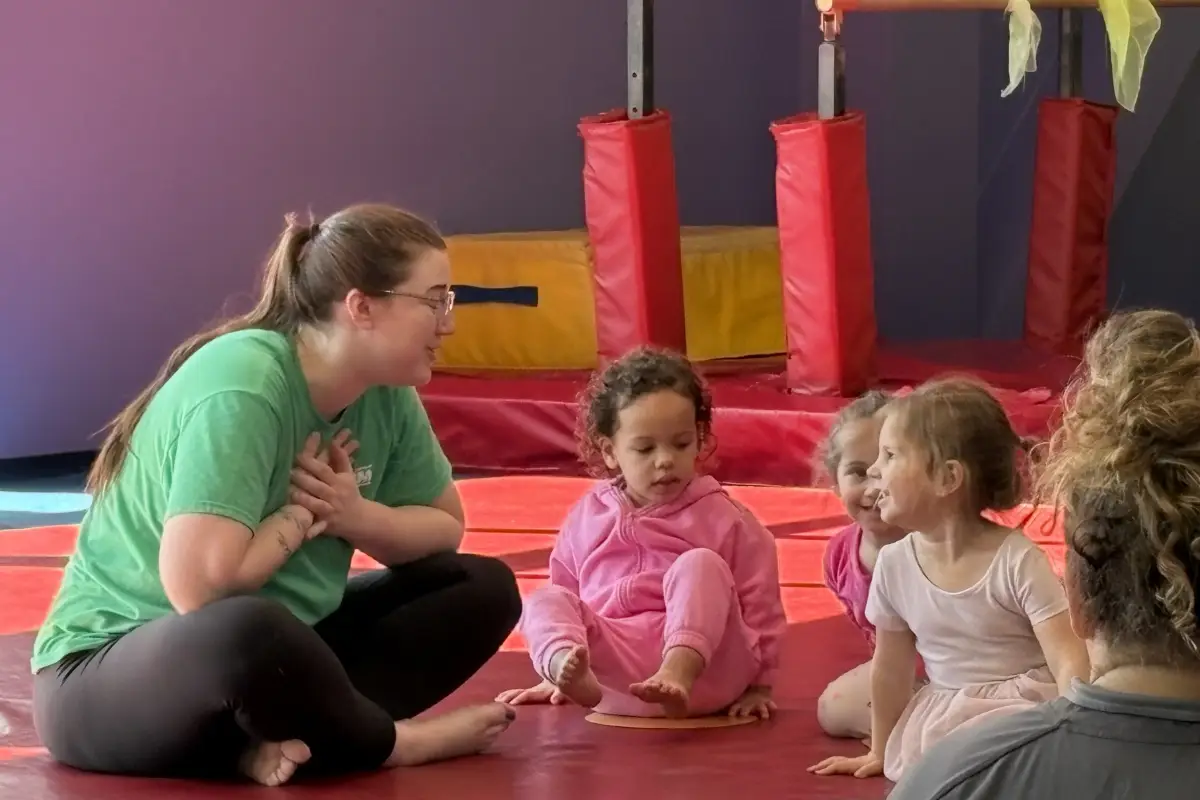 Teacher leading class with preschool aged children