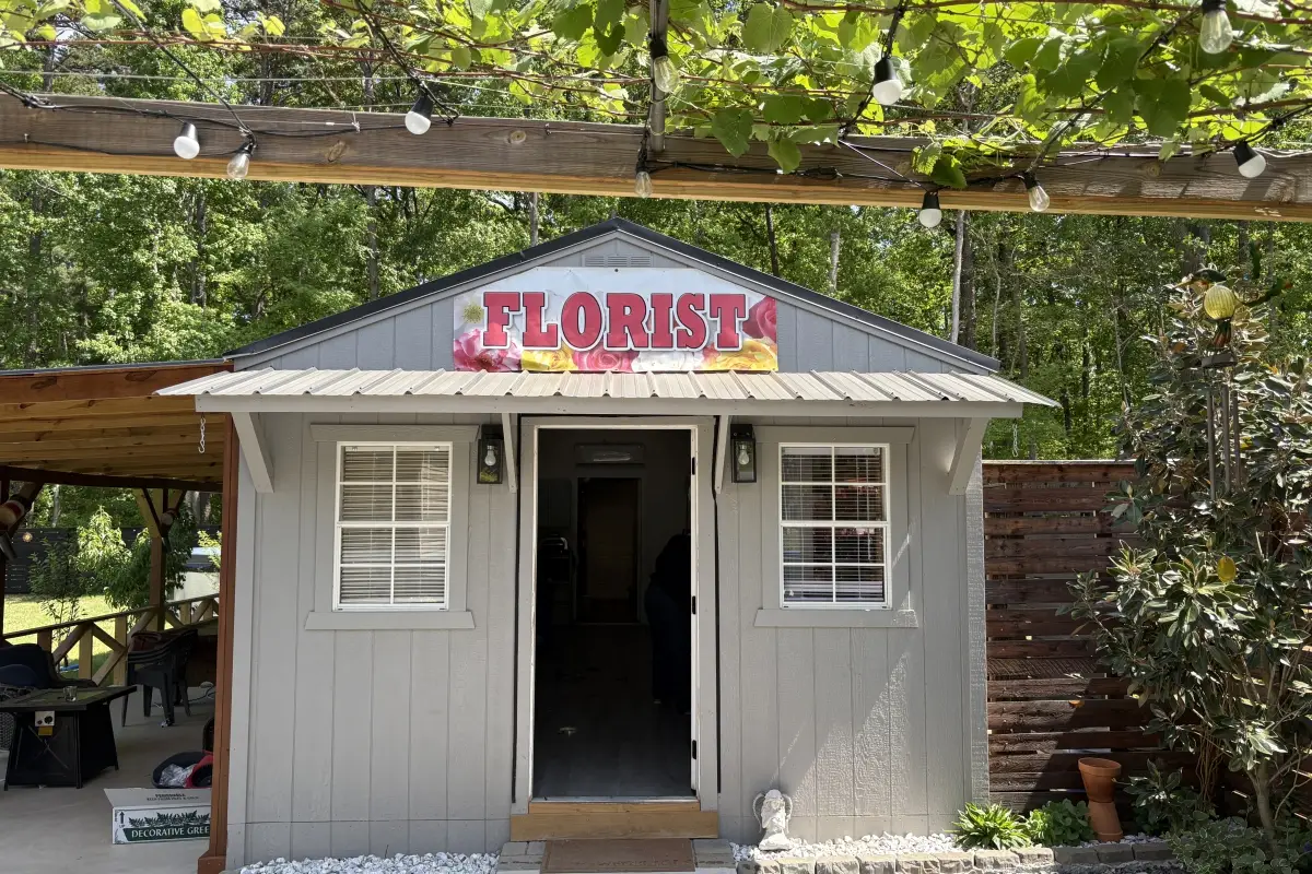 Exterior of Fleur D Amour florist shop in Huntersville with small storefront building and floral sign