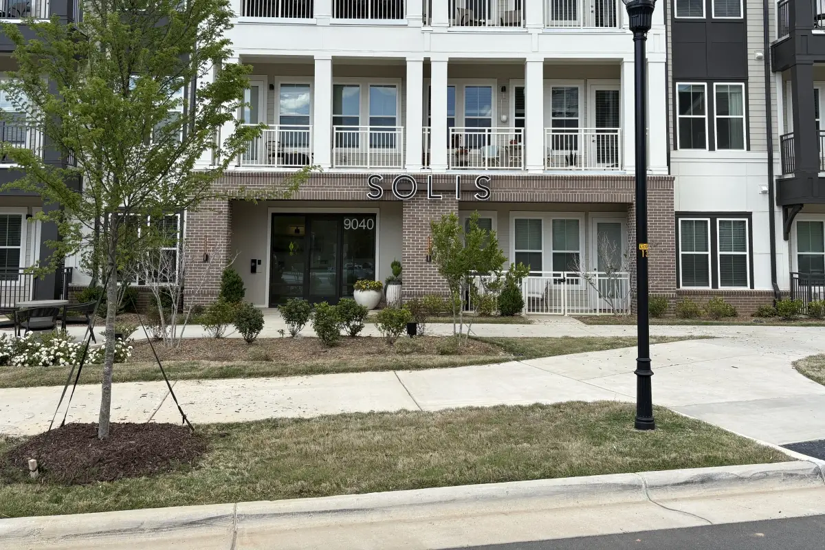 Exterior of Solis Birkdale apartment building with entrance and balconies visible