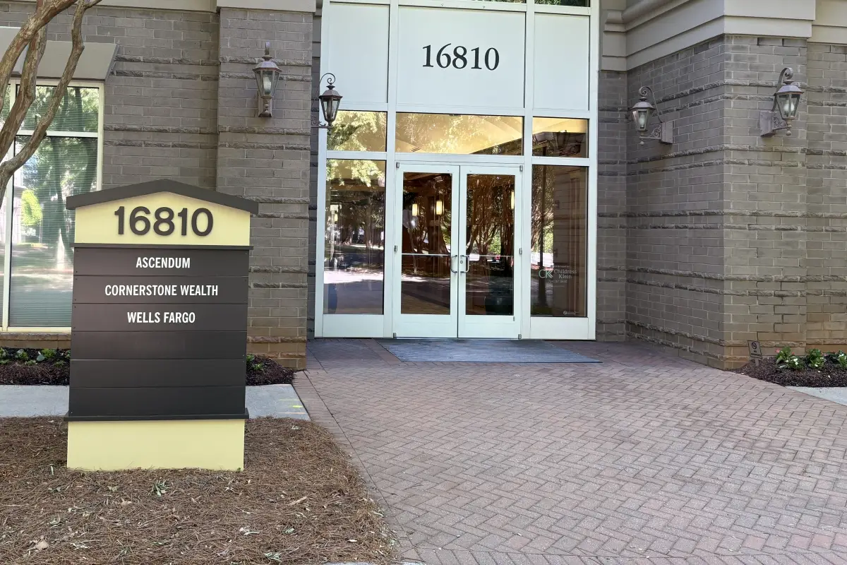 Office building entrance with directory sign listing Cornerstone Wealth Advisors 