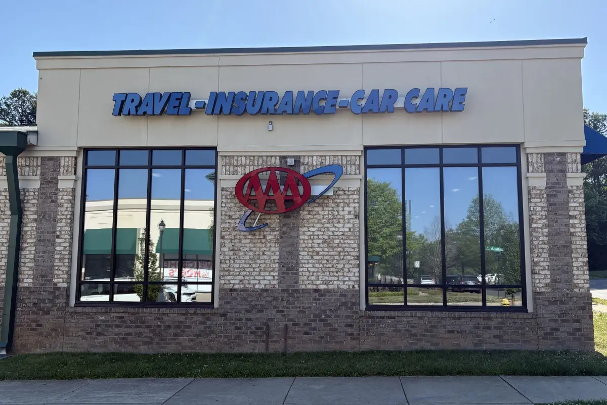 AAA office exterior with signage for travel, insurance, and car care services 