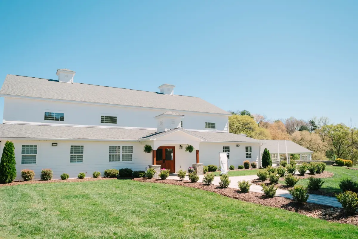 Exterior of The Ivory Barn event venue with landscaped grounds and entrance