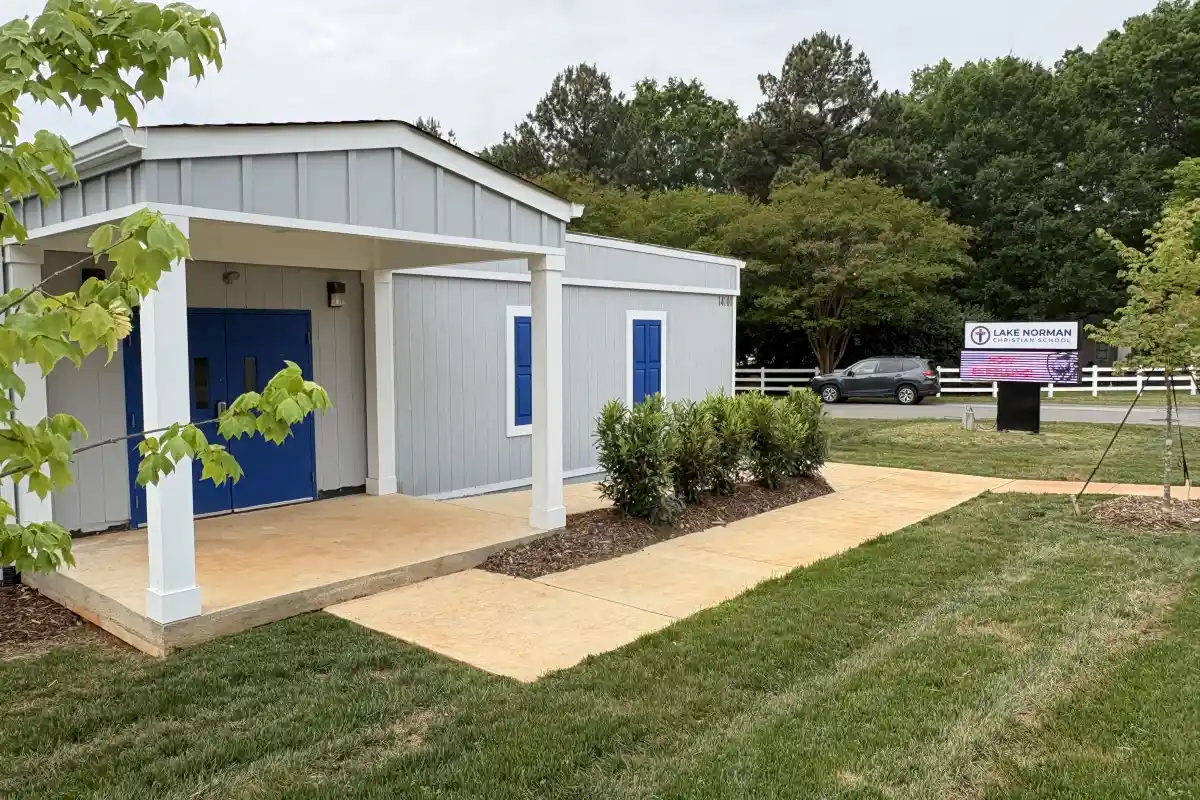 Walkway up to the entrance of Lake Norman Christian School with sign in the background