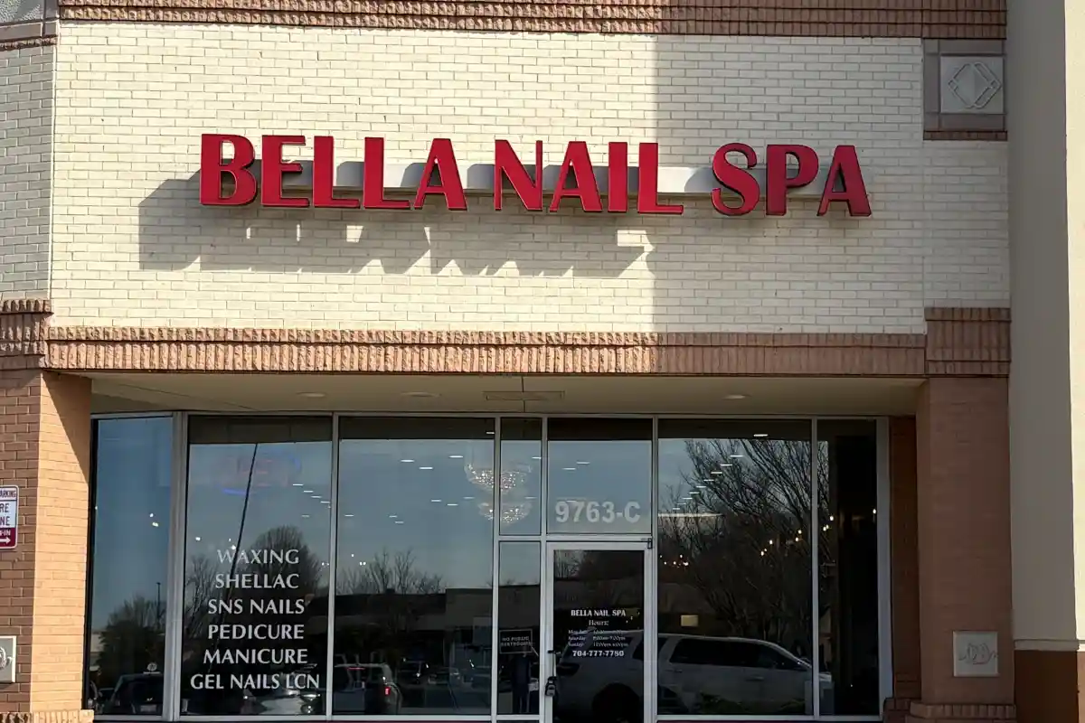Exterior entrance to Bella Nail Spa with signage about services